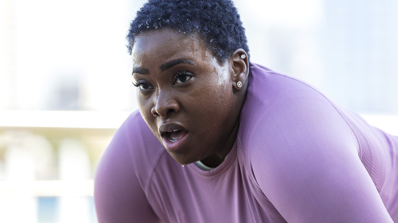 Woman sweating from excessive exercise 