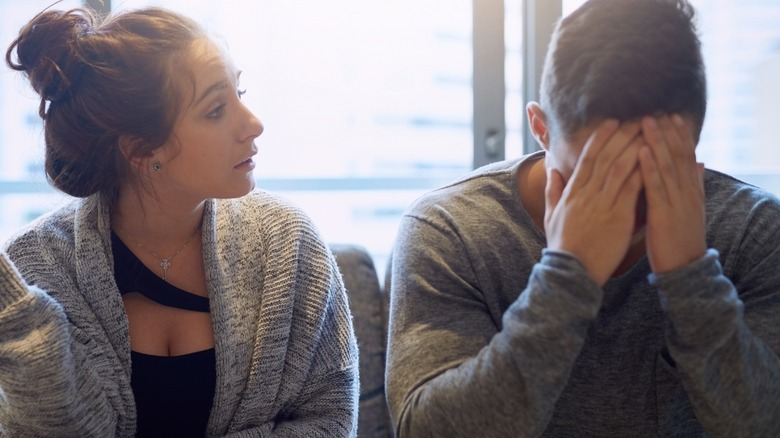 Woman talking to upset man