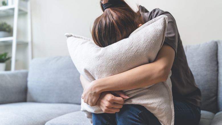 woman hugging pillow