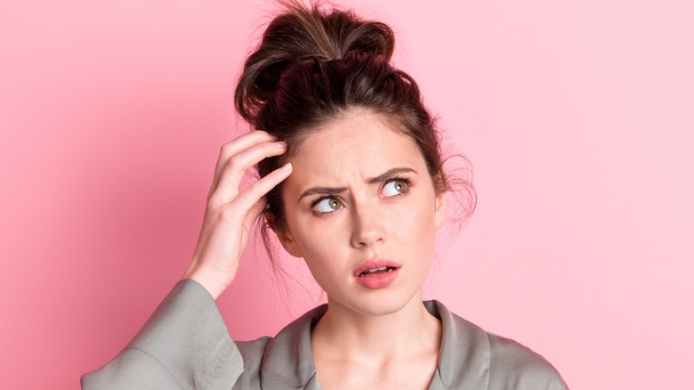 Woman scratching her head