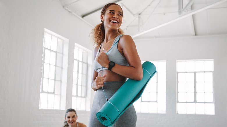 woman carrying yoga mat