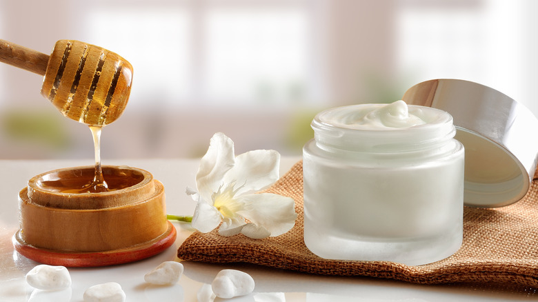 A jar of honey and moisturizer