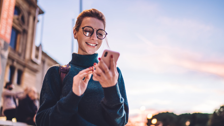 Woman smiling at her phone