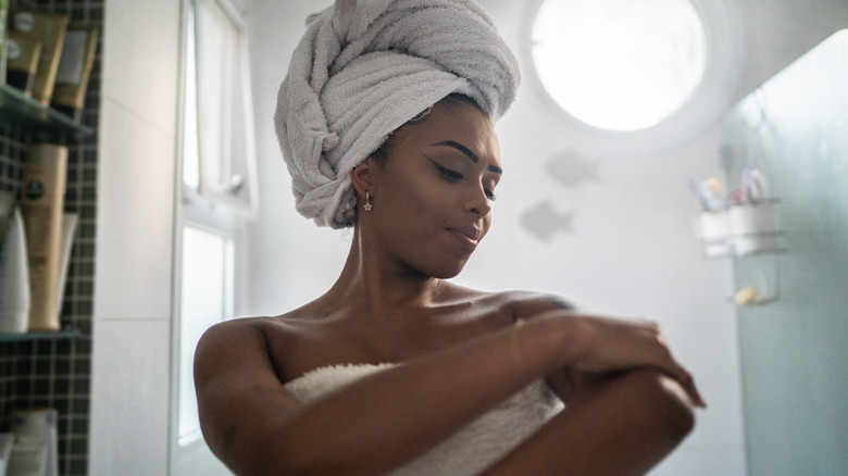 woman applying body oil