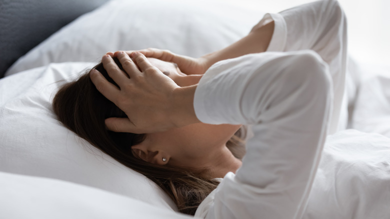 woman feeling unwell in bed