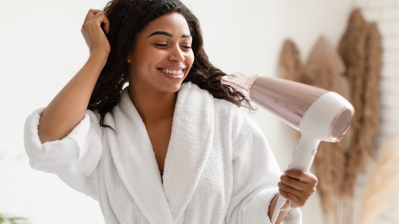 woman using hair dryer