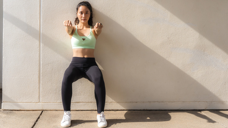 Woman doing wall sit