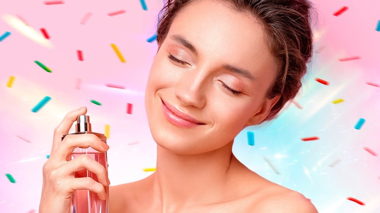 smiling woman spritzing perfume