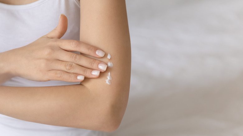 woman moisturizing elbows