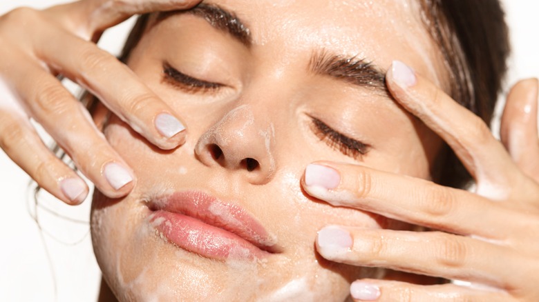 close up of woman using gel cleanser