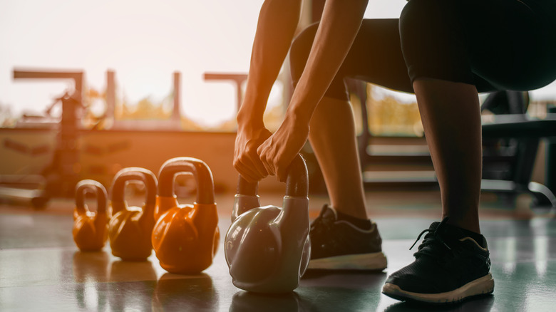 Woman squatting with kettlebell