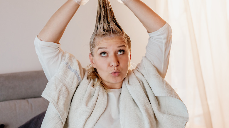 Woman applying hair mask