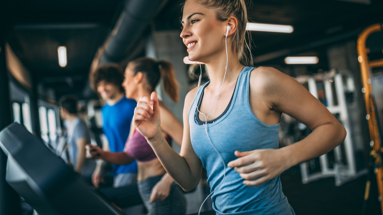 Woman wearing earbuds on treadmill