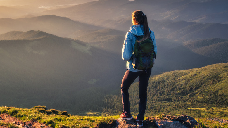 A hiking woman overlooking mountains