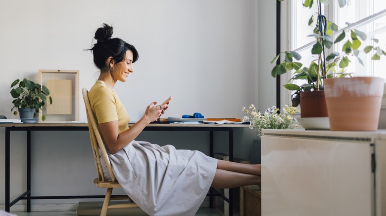 Brunette woman smiling at phone