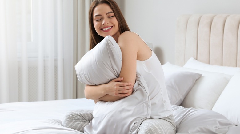 Smiling woman in silk sheets