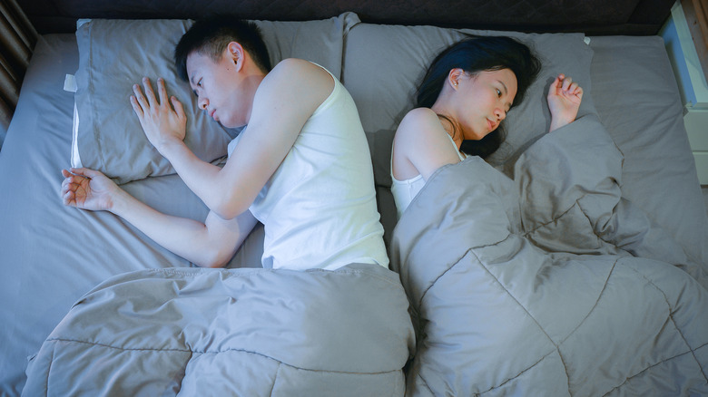 Disinterested couple in bed