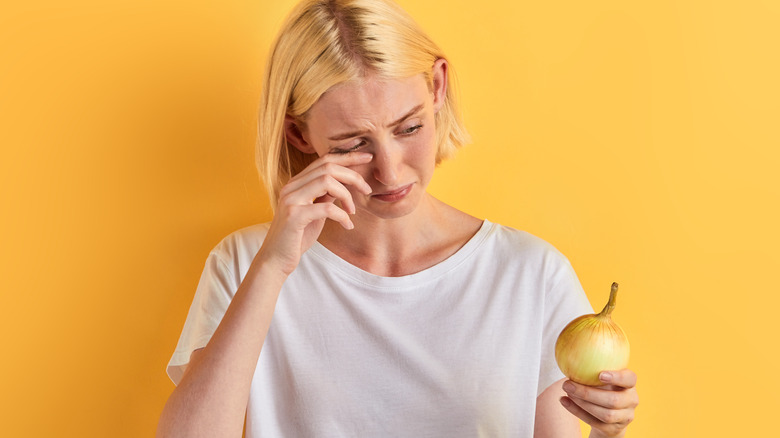 Woman holding onion 