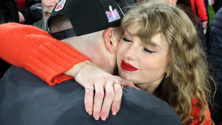 Taylor Swift hugging Travis Kelce