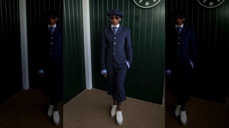Cynthia Erivo wears a pinstriped suit, tie, and newsboy cap at Wimbledon 2026