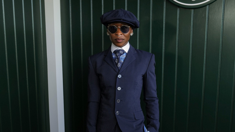 Cynthia Erivo wears a pinstriped suit, tie, and newsboy cap at Wimbledon 2026