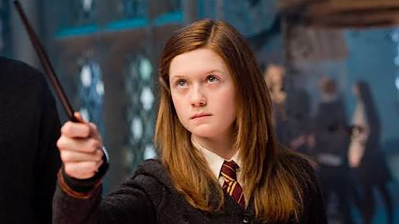 Ginny Weasley from Harry Potter holding a wand