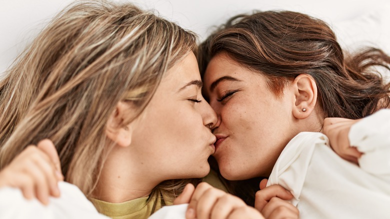 couple kissing in bed