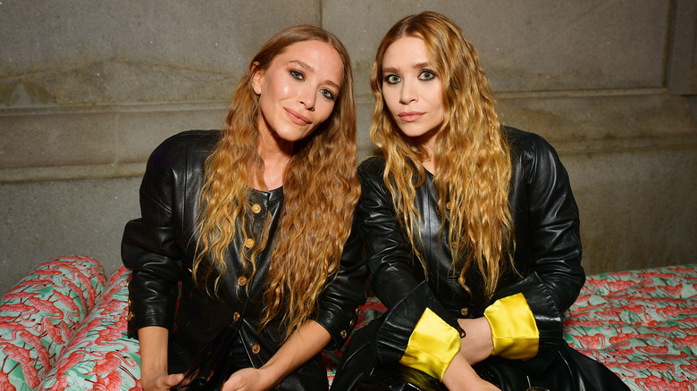 Mary Kate and Ashley Olsen sitting together
