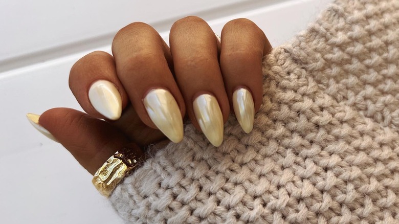 Pale yellow chrome manicure nails
