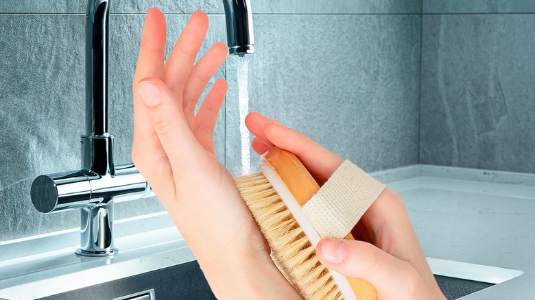woman dry brushing her hand