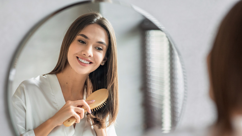 woman combing her hair