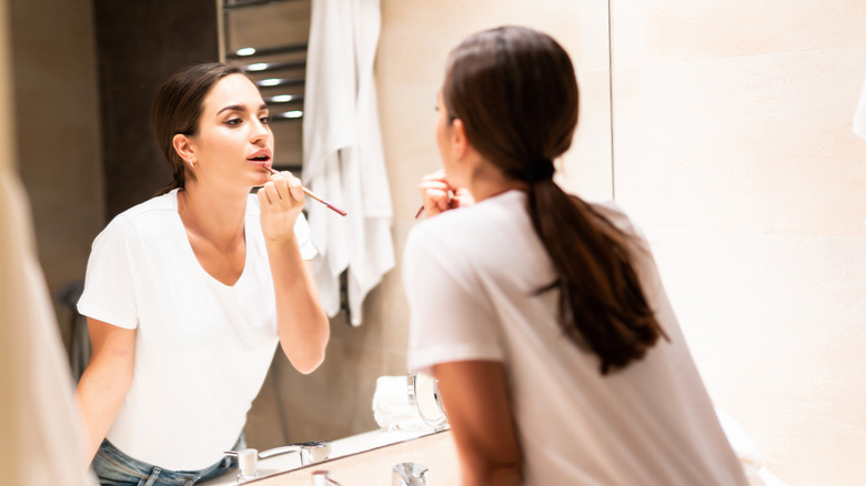 woman applying lip liner