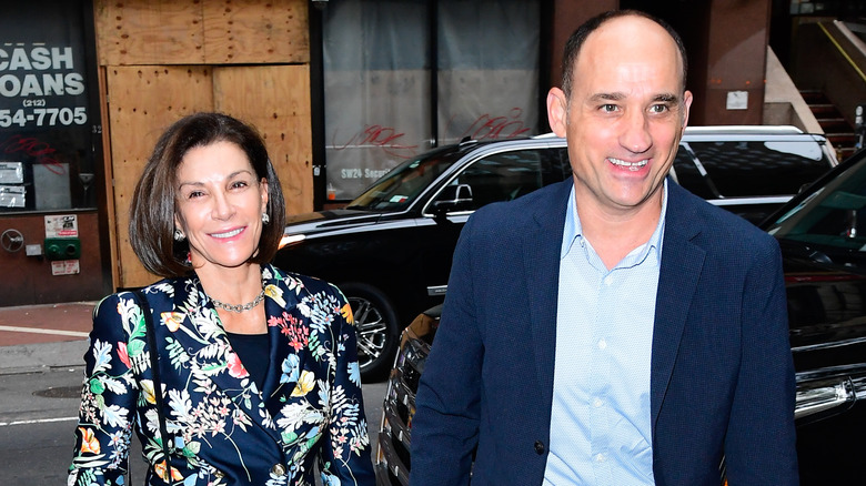 Hilary Farr wearing a botanical-print jacket and David Visentin walking together in New York City.