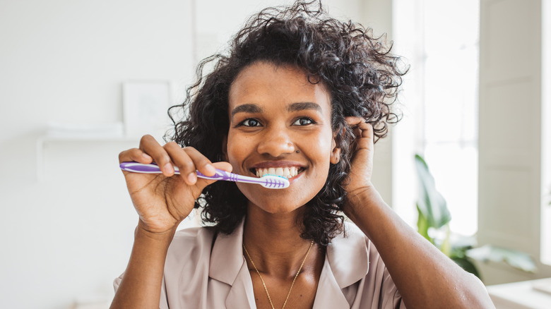 woman brushing teeth