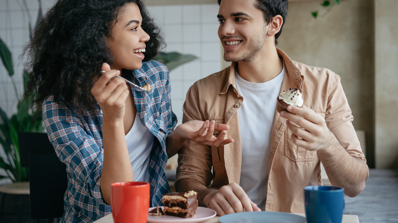 Man and woman eating desserts