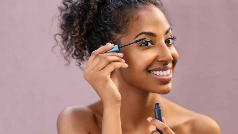 woman applying mascara