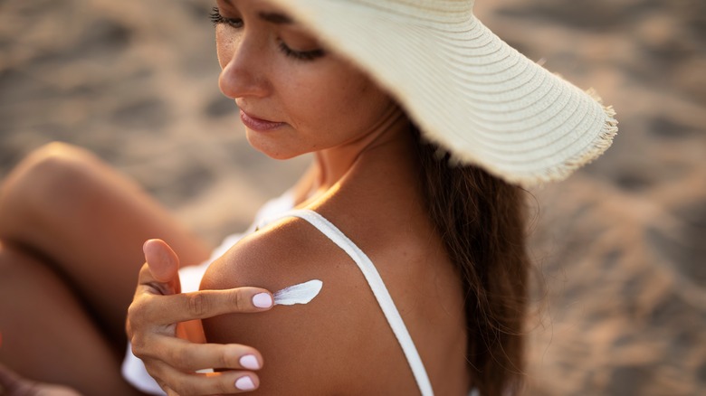 Sunburn woman with sunscreen