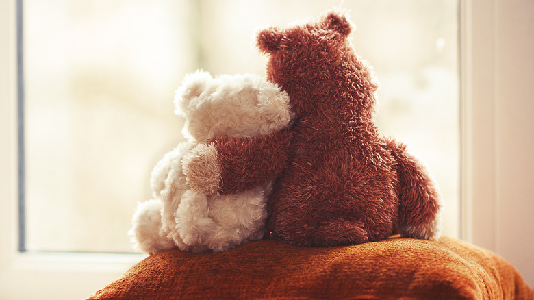 Two teddy bears hugging