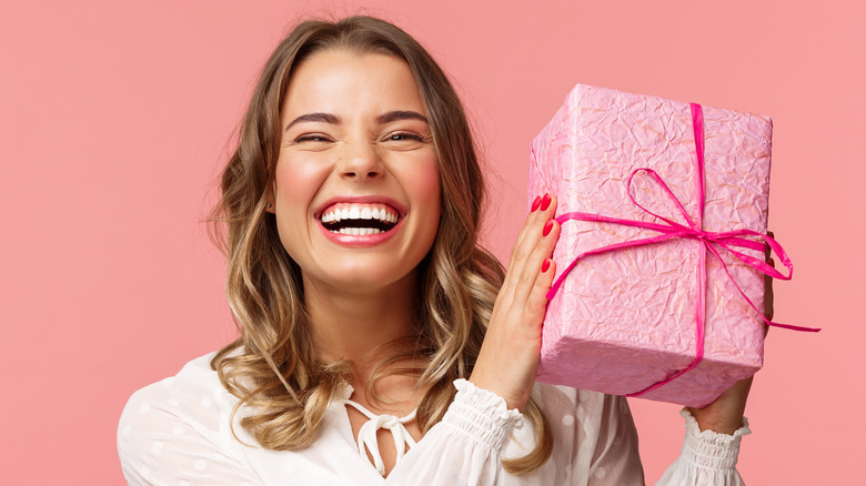 Model holding a pink gift box