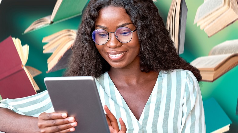 woman with glasses reading kindle