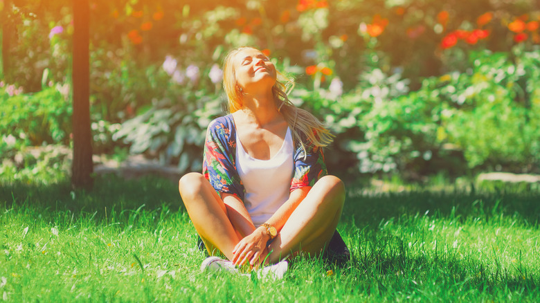 woman in grass looking up