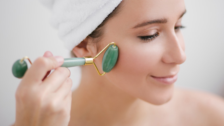 Woman using a jade roller