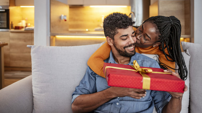 Woman giving gift to boyfriend