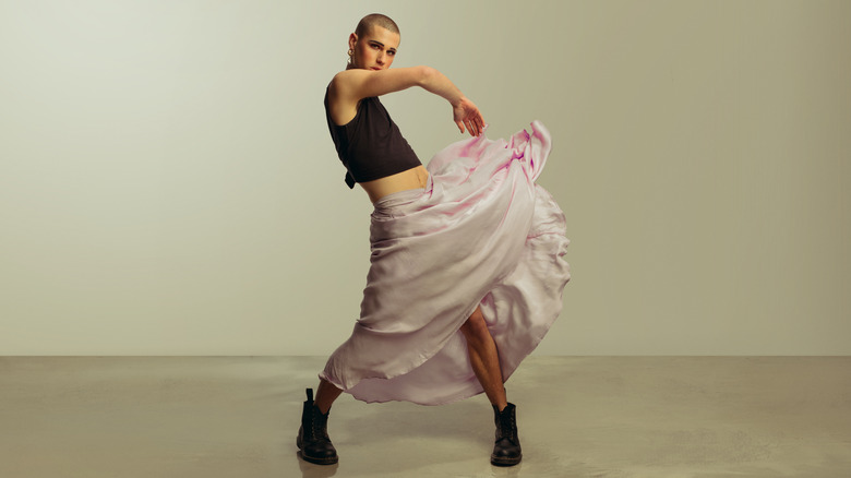 Androgynous model in flowing skirt
