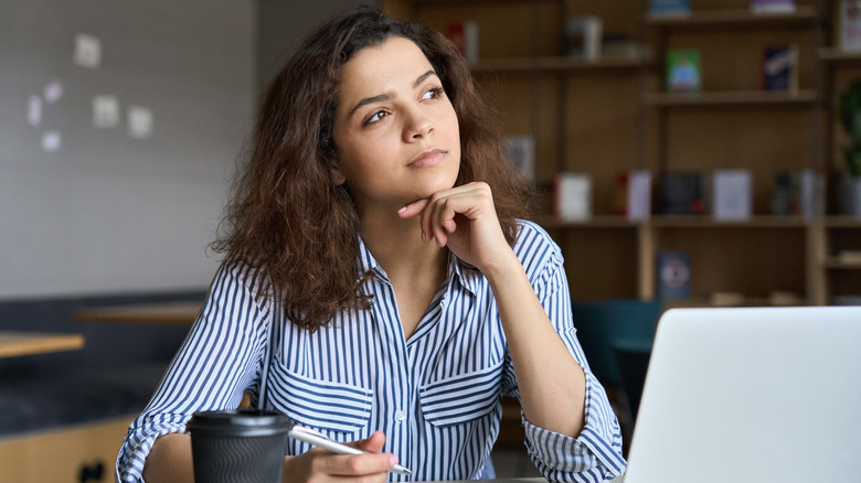 Woman daydreaming at desk