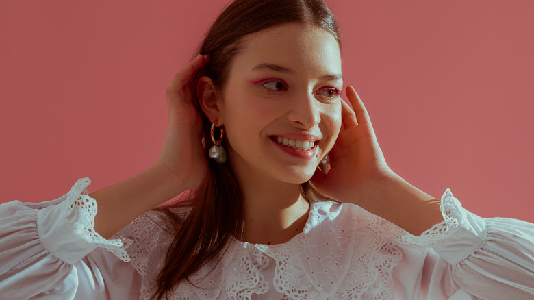 Girl wearing plazacore style top and pearls.