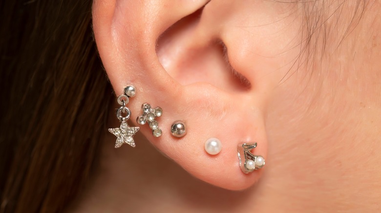 Woman's ear with many piercings