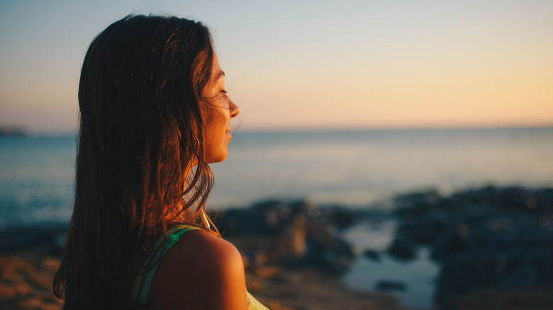 woman closing eyes outside