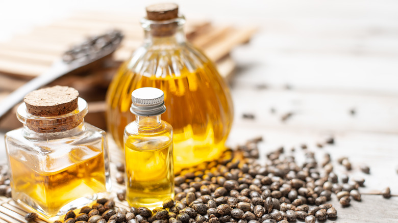 Castor oil bottles surrounded by seeds 