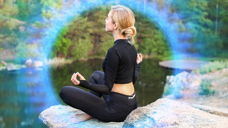 woman meditating in an aura